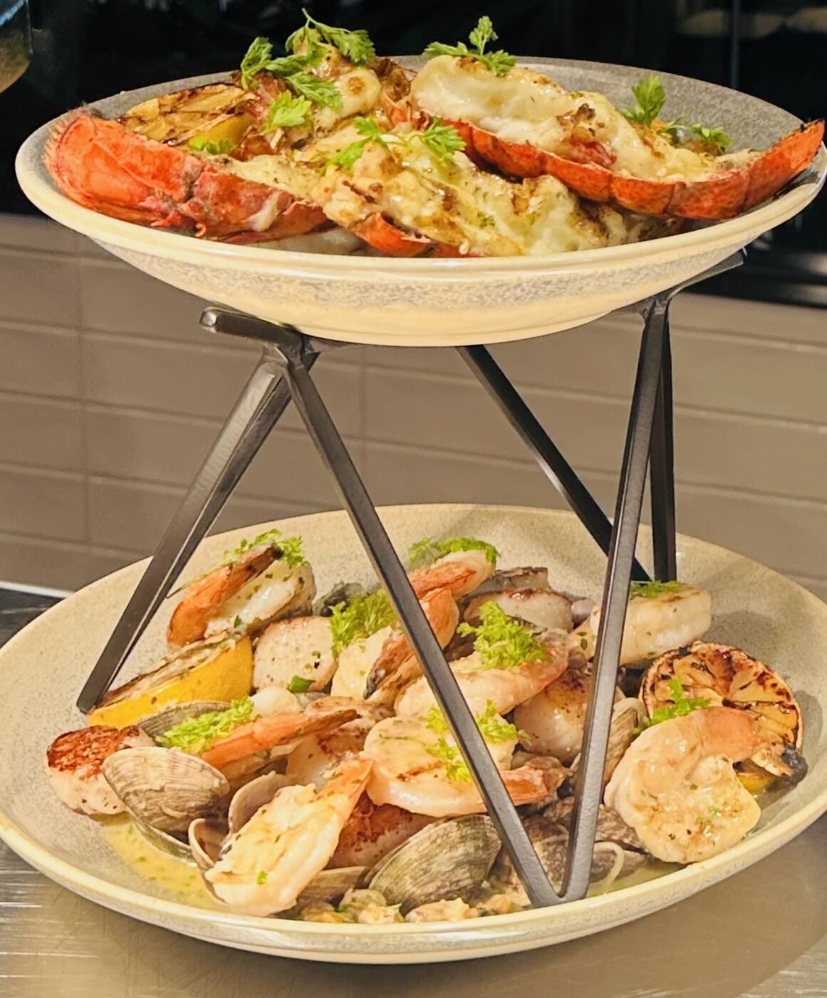 Tiered seafood display with lobster, shrimp, and clams