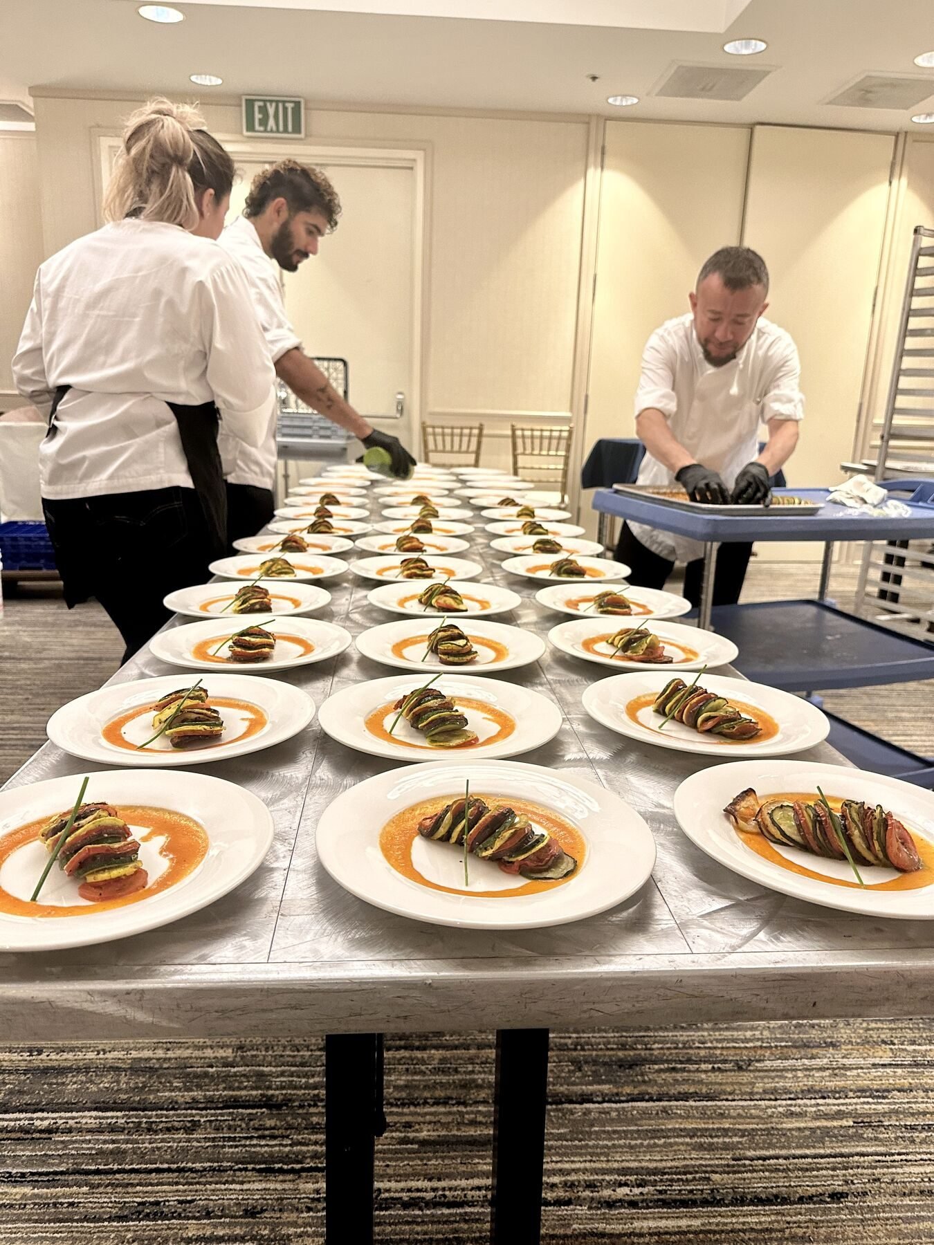 Chefs plating dozens of dishes for a large Bay Area event