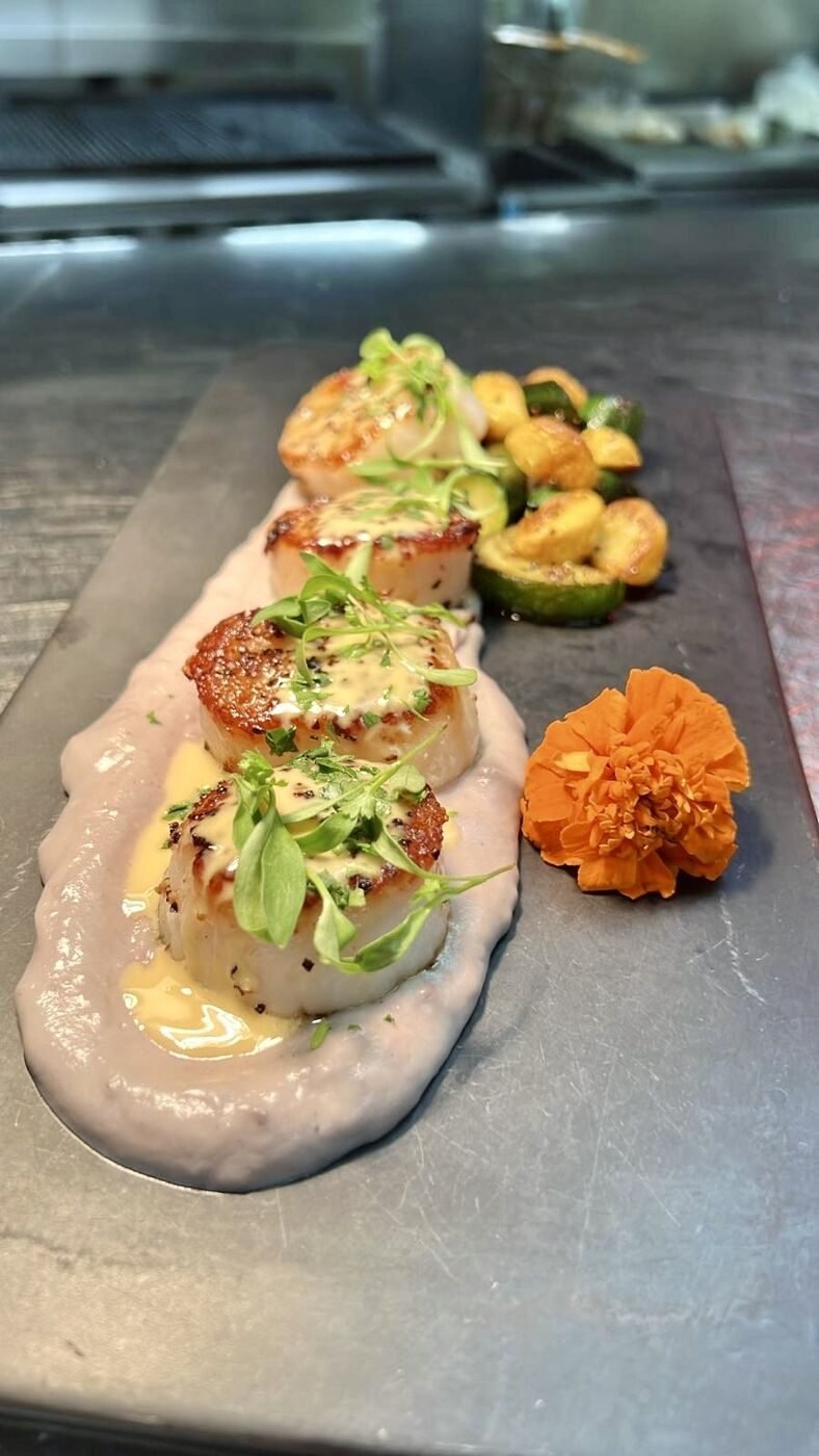 Seared scallops with beet puree and marigold